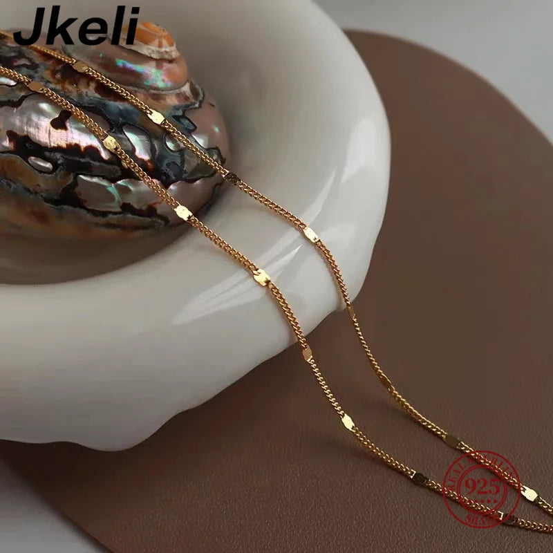 Sterling silver women's necklace by LAQTA with a delicate chain and elegant design, displayed on a neutral background.
