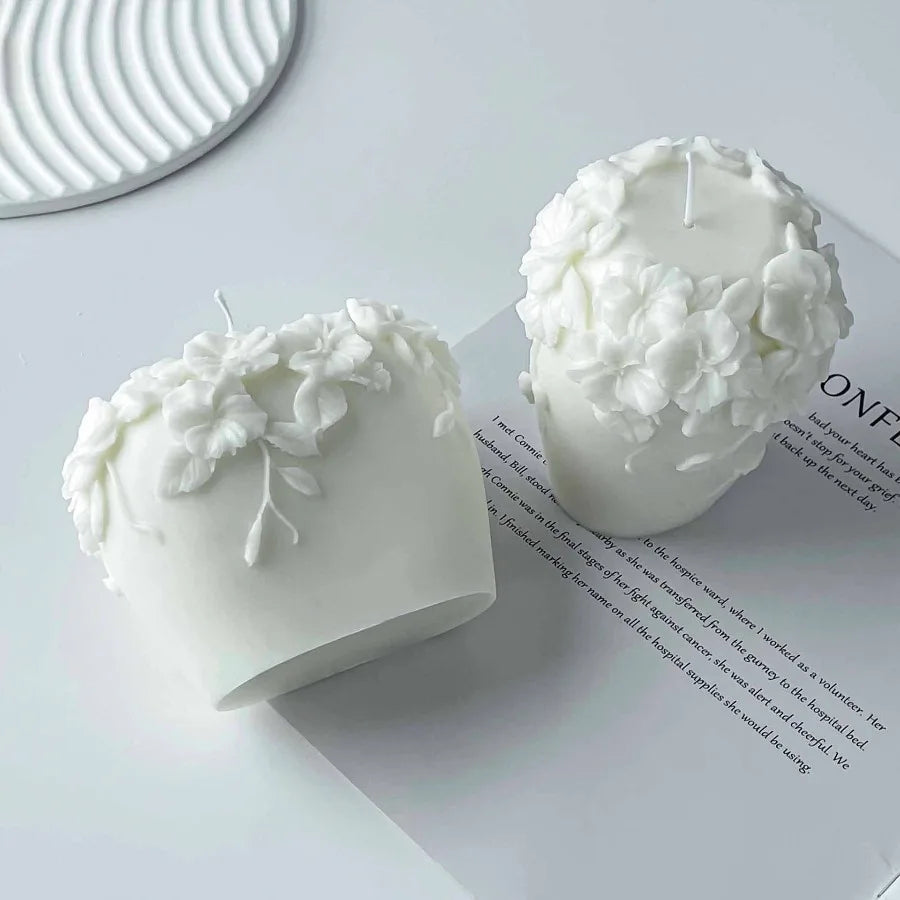 Nordic floral scented candle by LAQTA featuring a white ceramic holder and a lit wick, with floral patterns on the surface.
