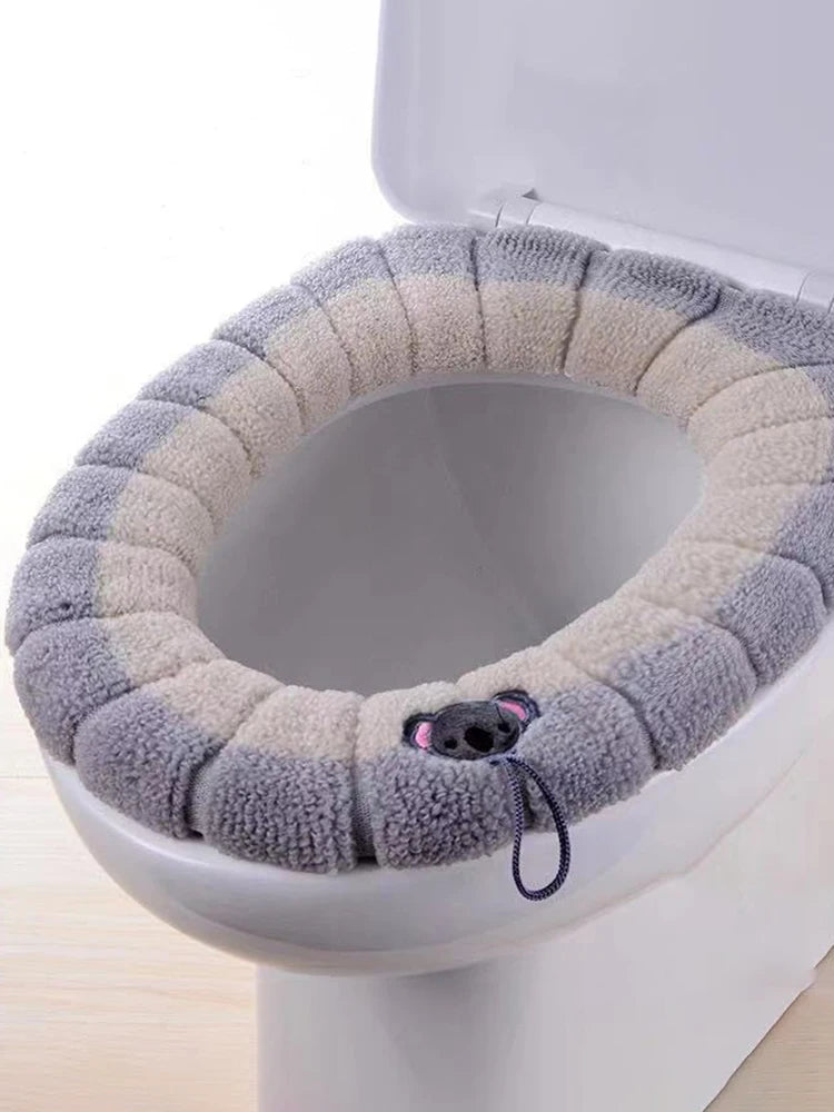 Colorful stitched portable knitted toilet mat by LAQTA, featuring soft, textured fabric and compact design for bathroom comfort.