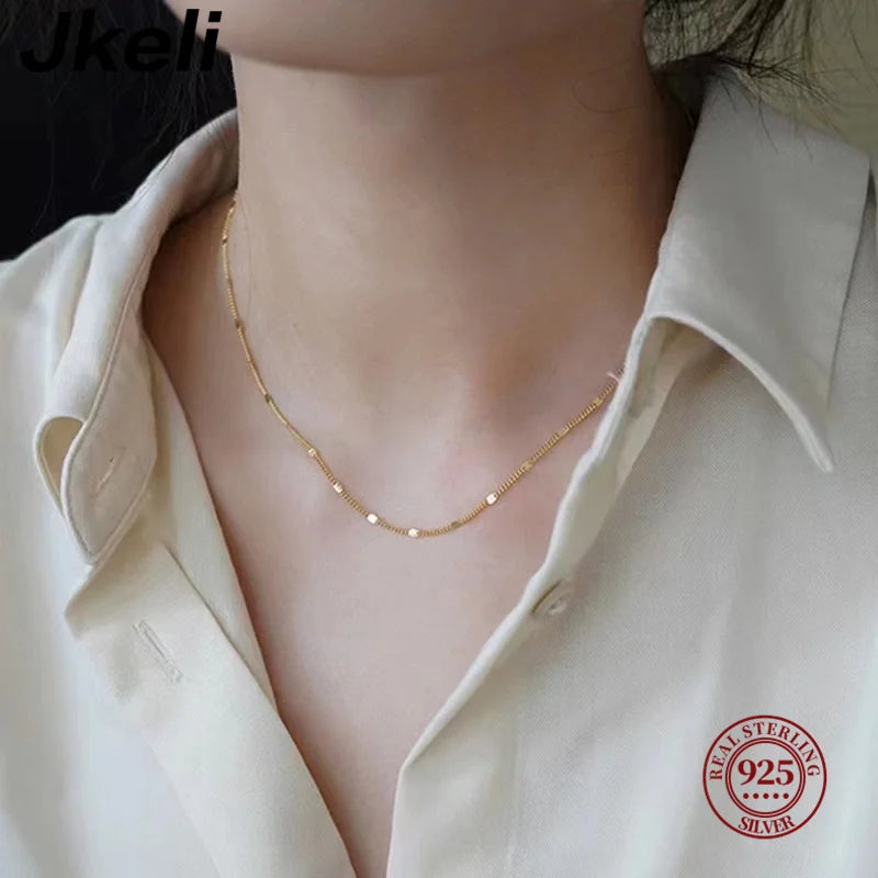 Sterling silver women's necklace by LAQTA with delicate chain and elegant pendant, displayed against a neutral background.