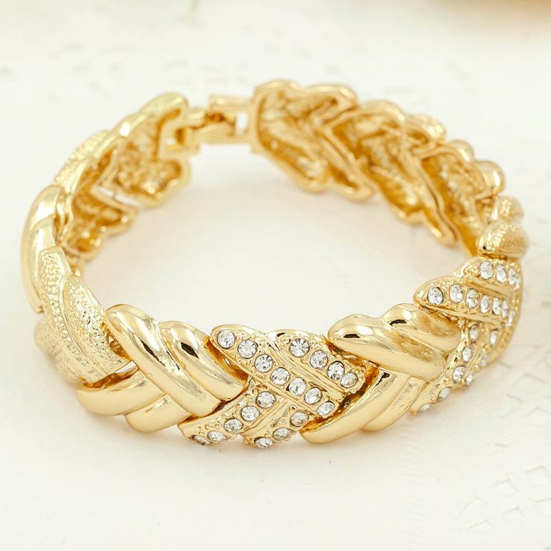 Elegant gold-colored Dubai fashion bridal jewelry by LAQTA with intricate design and sparkling embellishments.