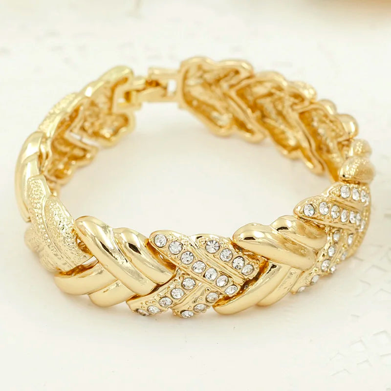 Elegant Dubai gold-colored bridal jewelry by LAQTA, featuring intricate designs and sparkling embellishments.