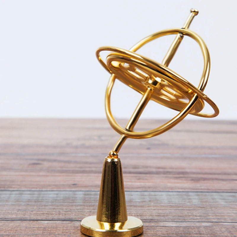 Metal anti-gravity spinning toy by LAQTA, showing a sleek, reflective metal sphere spinning in mid-air on a stand.