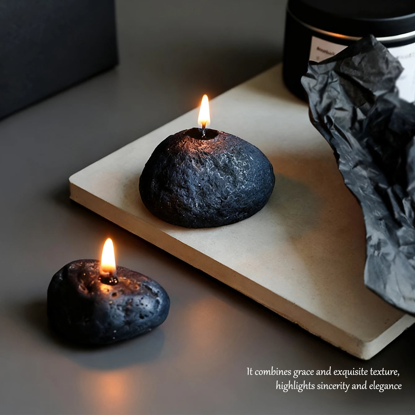 LAQTA Meteorite Scented Candle in a sleek container with a lit flame and textured surface, emitting a warm, inviting glow.