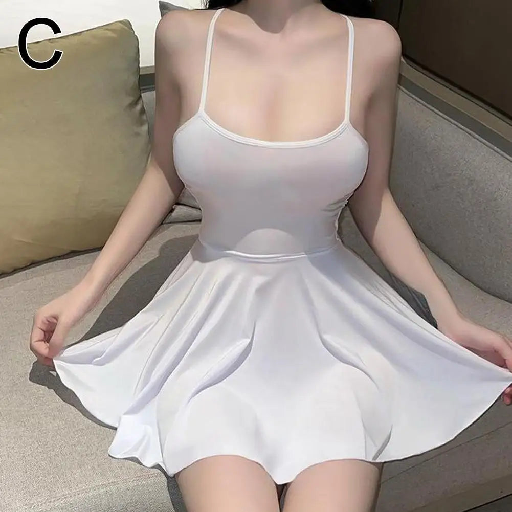 Black pleated micro dress by LAQTA featuring a fitted bodice and short length, shown on a mannequin.