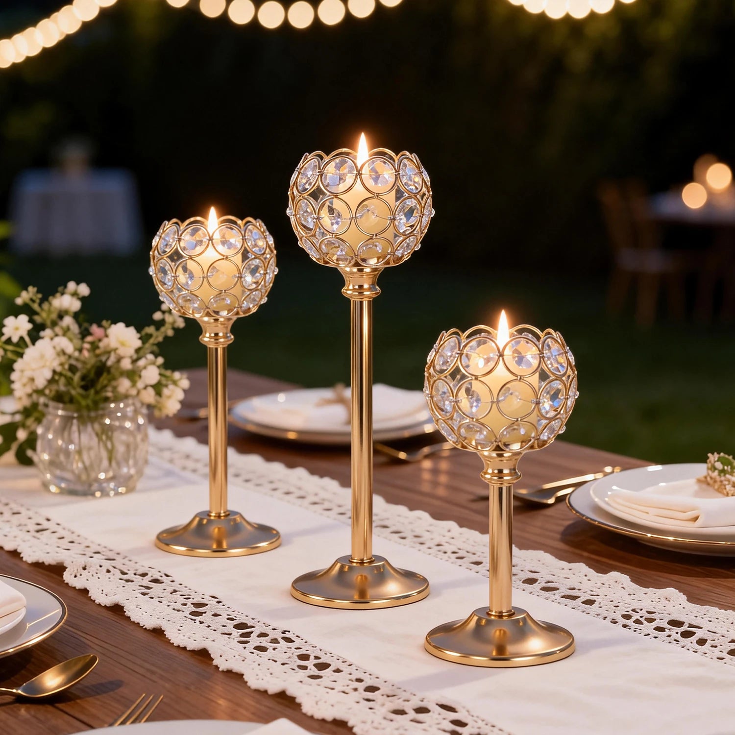 Elegant gold and silver metal glass candle by LAQTA with intricate design and warm glow.