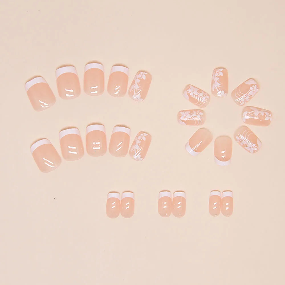 Set of 24 short square-shaped acrylic nails by LAQTA, neatly arranged in a display with various natural and trendy nail designs.