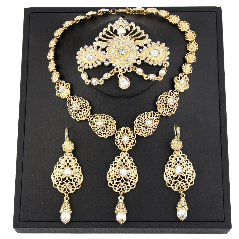 Elegant Moroccan bride jewelry set by LAQTA featuring intricate gold and gemstone accessories for traditional wedding attire.